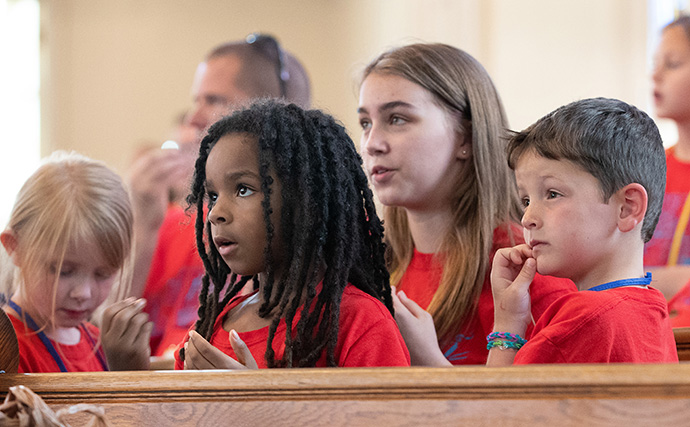 Children listen to a lesson during vacation Bible school at Connell Memorial United Methodist Church. From left are: Abby Hartmann, Emma Furtado, Emme Sinclair Krueger and Barrett Christian. Photo by Mike DuBose, UM News.