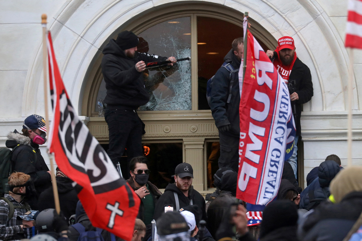 A man breaks a window as supporters of U.S. President Donald Trump storm the U.S. Capitol building in Washington on Jan. 6, 2021. Discipleship Ministries is offering a new Courageous Conversations resource to help United Methodists talk about Christian nationalism in a respectful way. REUTERS/Leah Millis. 