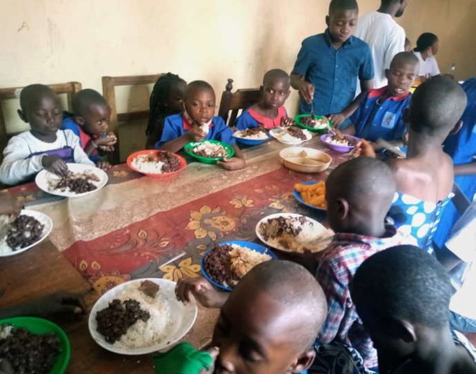 Orphans at United Methodist Goma Orphanage share a meal in the refectory after receiving food provided through donations from United Methodists. The church in Congo is helping some 40 orphans who lost their parents in a May 22 volcanic eruption. Photo by Philippe Kituka Lolonga, UM News. 