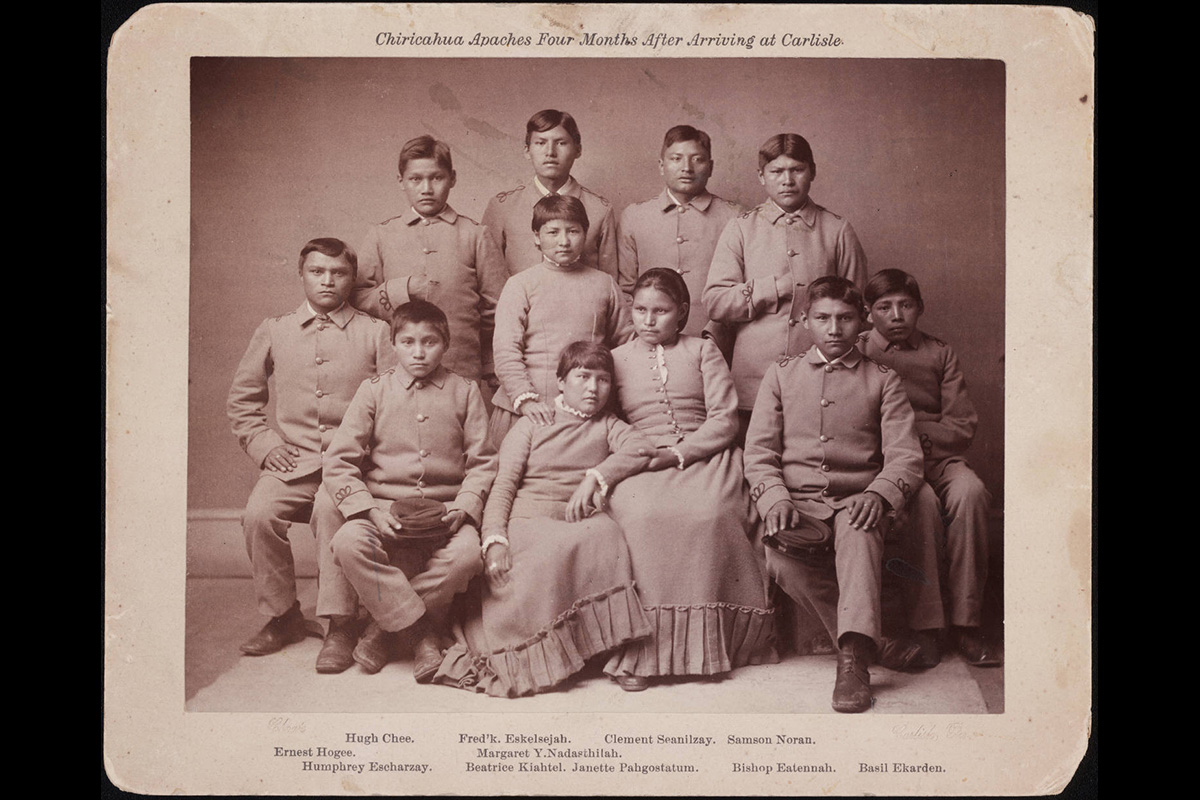 This portrait from 1887 shows people from the Chiricahua band of Apache Native Americans about four months after their arrival at the United States Indian Industrial School in Carlisle, Pa. Native Americans were taken from their homes and enrolled in boarding schools for many years, separating students from both their families and their culture. Image courtesy of the Richard Henry Pratt Papers, Beinecke Rare Book & Manuscript Library, Yale University via Wikimedia Commons.