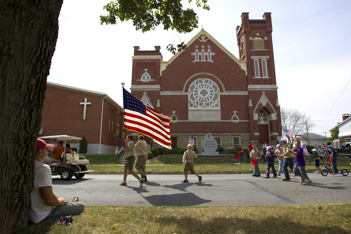 Boy Scouts parade in front of Leipsic (Ohio) United Methodist Church during the town's Fall Festival in 2010. As the Boy Scouts of America’s sex abuse-triggered bankruptcy proceeds, United Methodist congregations are hearing from denomination leaders to hold off on renewing chartering relationships with Boy Scout troops. File photo by Mike DuBose, UM News.
