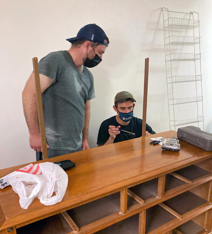 Zach Lenkay (left) and John Densham of Kingstowne Communion, a United Methodist church in Alexandria, Va., assemble furniture for an Afghan refugee family that the church is helping to sponsor. Photo courtesy of Kingstowne Communion.
