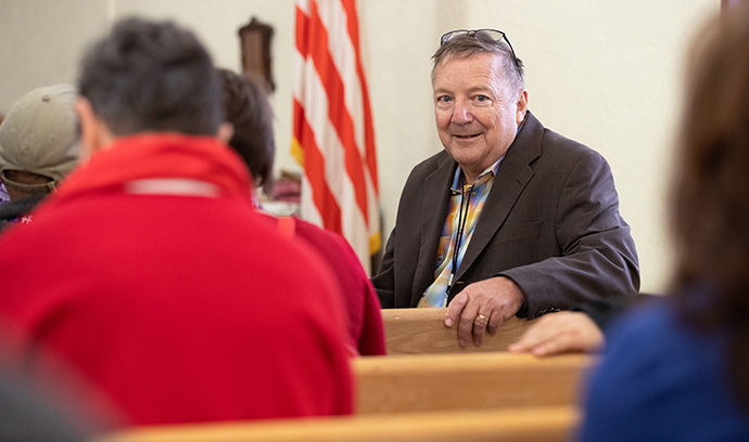 The Rev. George Miller briefs members of the United Methodist Immigration Task Force on a transitional shelter for immigrants at El Calvario United Methodist Church in Las Cruces, N.M., in 2019, when the church was preparing to host migrants who had crossed into the U.S. from Mexico. The church is now collecting supplies for Afghans whose first stop is a nearby U.S. military base. File photo by Mike DuBose, UM News.