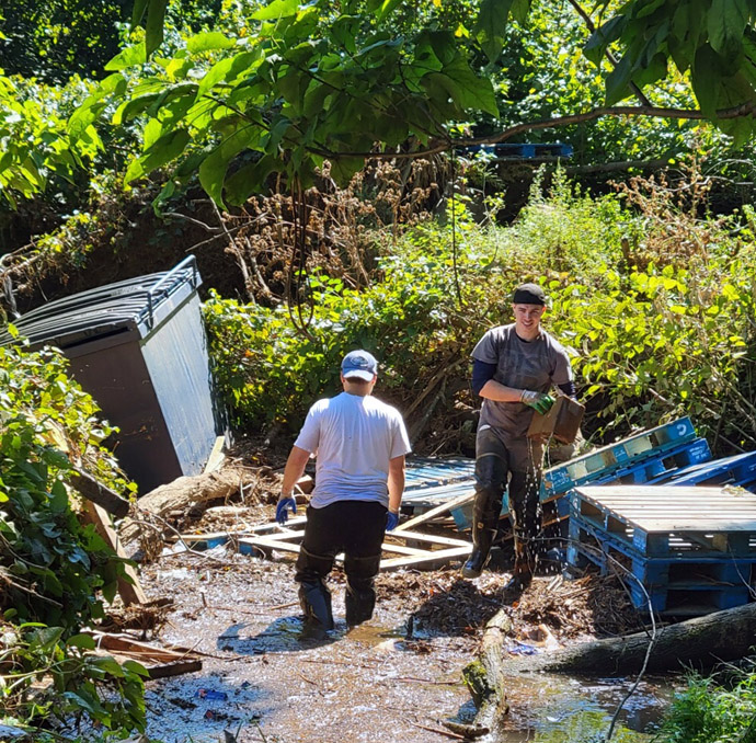 Members of United Methodist Church of Bound Brook, in Bound Brook, N.J., haul out church items that ended up in a nearby creek during Hurricane Ida. Photo courtesy of the Rev. Mcwilliam Colon.