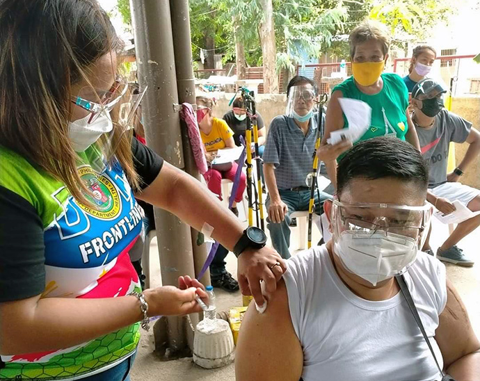 The Rev. Marvin Sulayao De Leon of Manena United Methodist Church in Bulacan, Philippines, receives a COVID-19 vaccine at San Miguel Bulacan Vaccination Center. United Methodists in the Philippines have worked with the government to fast-track vaccinations for church leaders, who are not categorized as front line workers, so that their ministry with the community can continue safely. Photo courtesy of  Glessie Yambot De Leon.