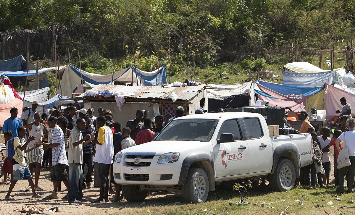 A team from the United Methodist Committee on Relief, along with partner agencies, distributes water treatment supplies to people living in a makeshift camp in Gressier, Haiti, in 2010. The board of United Methodist Global Ministries and the United Methodist Committee on Relief has earmarked $110,000 to provide disaster relief in Haiti. File photo by Mike DuBose, UM News.