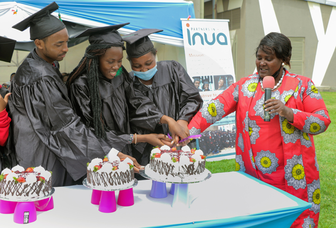 Graduates cut a cake to commemorate their completion of the Inua Partners in Hope vocational training program in Naivasha, Kenya. The program provides orphans and vulnerable young people with job skills training through a variety of programs including carpentry, construction, dressmaking, general mechanics, hairdressing and welding. Photo by Gad Maiga, UM News.