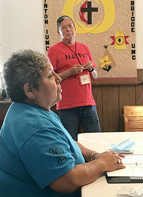 The Rev. Donna Pewo describes how Clinton Indian Church and Community Center is working to help children and youth, as the Rev. David Wilson listens. Wilson and Pewo are on staff with the Oklahoma Indian Missionary Conference. Photo by Tim Tanton, UM News.