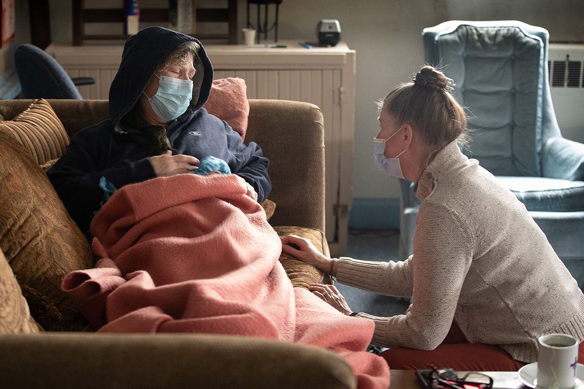 The Rev. Ruth Marsh (right) comforts Angi Rogers, a guest in the day shelter at Trinity United Methodist Church in Idaho Falls, Idaho. Rogers had not been feeling well and Marsh settled her in a Sunday school classroom to get some rest. “Everybody here takes care of me and each other,” Rogers said. Photo by Mike DuBose, UM News.