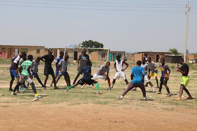 Des pensionnaires de la Glen View Football Academy s’entraînent au football sur un terrain de fortune près de Harare, au Zimbabwe. Ils font partie d’un programme Méthodiste Uni qui assiste les jeunes toxicomanes et d’autres jeunes vulnérables afin de les mettre sur une meilleure voie. Photo d’Eveline Chikwanah, UM News.