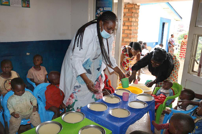 Dr. Marie Claire Manafundu, program officer for the Maternal and Child Health Program in East Congo, serves porridge to malnourished children at United Methodist Irambo Hospital in Bukavu, Congo. Photo by Philippe Kituka Lolonga, UM News.