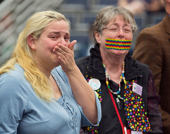 Supporters of equality for LGBTQ people in the life of The United Methodist Church, some with their mouths taped shut, stand outside the bar of the 2016 United Methodist General Conference in Portland, Ore., to symbolize the way LBGTQ people feel they are silenced by the church. File photo by Mike DuBose, UM News.