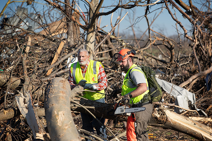 United Methodist volunteers David Stilgenbauer (left) and Chad Barker from West Virginia clear tornado debris in Cayce, Ky., in December 2021. Stilgenbauer is Volunteers in Mission coordinator for the West Virginia Conference. Photo by Mike Dubose, UM News.