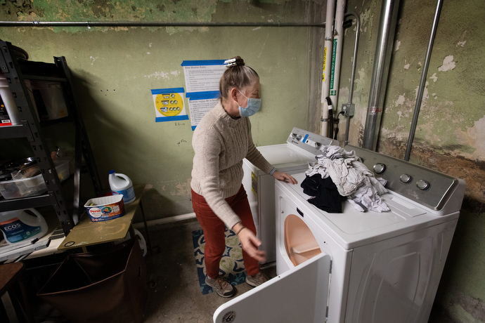 The Rev. Ruth Marsh does laundry in the church basement for a guest of the day shelter at Trinity United Methodist Church. Photo by Mike DuBose, UM News.