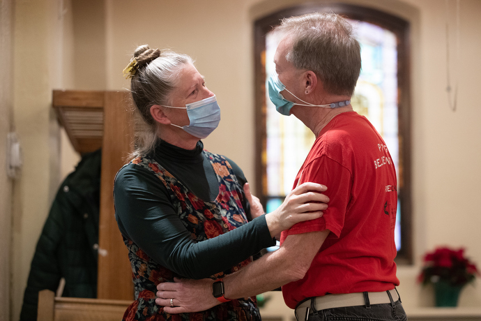 The Rev. Ruth Marsh and her husband, David Armstrong, embrace before Sunday worship at Trinity United Methodist Church. Armstrong served as liturgist during the service. Photo by Mike DuBose, UM News.