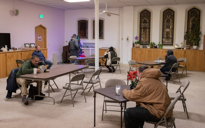 Guests eat dinner at Trinity United Methodist Church. The church serves as a day shelter for people living on the streets. Photo by Mike DuBose, UM News.