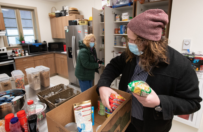 Logan Pickens (front) and volunteer Sharon Stickley stock food for day shelter guests in the kitchen at Trinity United Methodist Church. Photo by Mike DuBose, UM News.