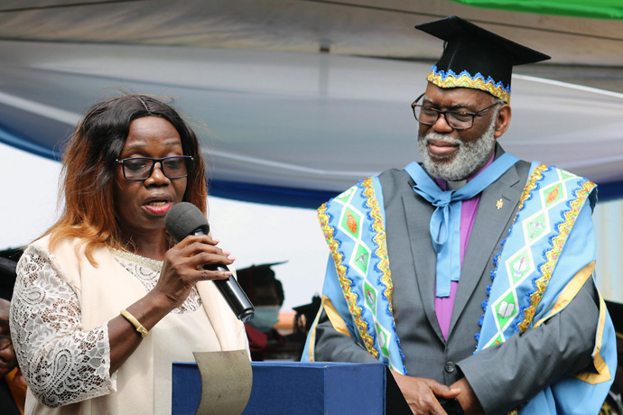Interim Sierra Leone Conference Bishop Warner H. Brown (right) watches as Millicent Yambasu receives a posthumous award on behalf of her late husband, Bishop John K. Yambasu, who founded the United Methodist University in Sierra Leone. The first set of students enrolled in the university graduated Feb. 26 at the Leicester Peak campus. Photo by Phileas Jusu, UM News. 