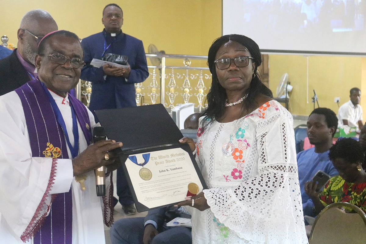 Archbishop Michael Kehinde Stephen presents the posthumous World Methodist Peace Award to Millicent Yambasu, wife of late Sierra Leone Bishop John K. Yambasu, during a Service of Remembrance and Resurrection in Bo, Sierra Leone. Bishop Yambasu received the award for his work as a leader and peacemaker in Sierra Leone and The United Methodist Church. Photo by E Julu Swen, UM News.