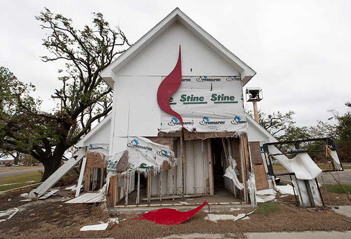 The United Methodist Cross and Flame logo lies in pieces after Hurricane Laura tore through Wakefield United Methodist Church in Cameron, La., in 2020. Scientists have attributed an increase in storm activity to unusually warm surface temperatures in the Atlantic Ocean. File photo by Mike DuBose, UM News.