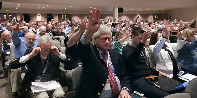 Attendees of the Wesleyan Covenant Association’s May 7 Global Gathering lift their hands as they pray for the WCA’s leaders. Photo by Sam Hodges, UM News.