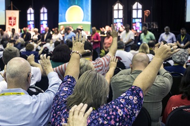 Attendees of the 2017 Kentucky Annual Conference in Bowling Green, Ky., raise their arms in prayer during a "Worshipful Work, Plenary." On May 10, The Judicial Council released a ruling that says U.S. annual conferences cannot disaffiliate from the denomination under current church law. File photo by Kathleen Barry, UM News. Attendees of the 2017 Kentucky Annual Conference in Bowling Green, Ky., raise their arms in prayer during a "Worshipful Work, Plenary." On May 10, The Judicial Council released a ruling that says U.S. annual conferences cannot disaffiliate from the denomination under current church law. File photo by Kathleen Barry, UM News.