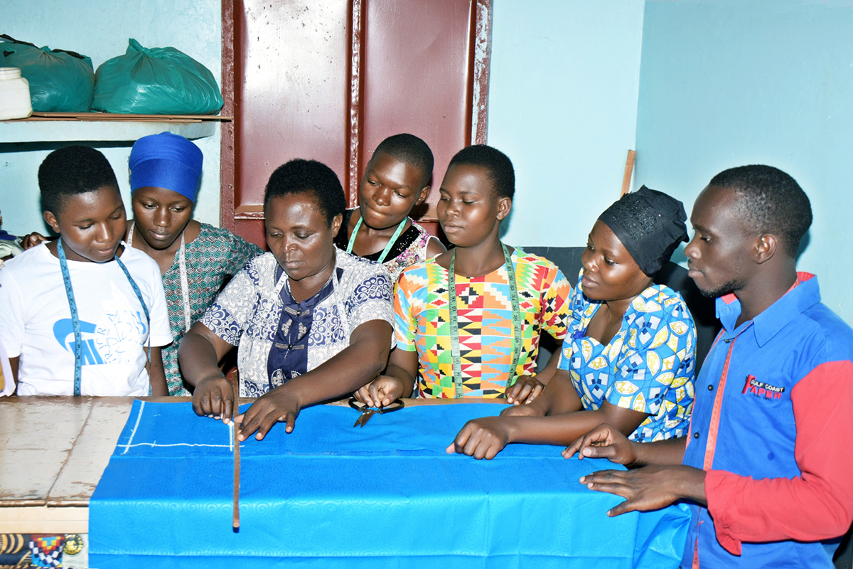 Students learn how to draw and mark measurements on sewing material during a lesson at the United Methodist Church Women Training Center in Bugembe, Uganda. The center works with women, youth, rape survivors, displaced people and others in the community. The goal is to improve livelihoods through vocational training and education. Photo by Gad Maiga, UM News. 