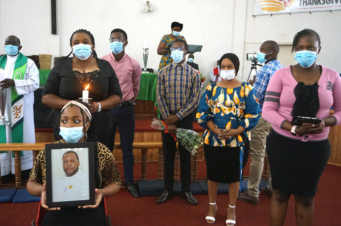 Gloria Benhura (third from left with candle) lost her husband, Garikai, during the global pandemic. She and her family honored Garikai during a special memorial at Chisipiti United Methodist Church in Zimbabwe. Benhura said she and her husband always attended services together. Photo by Kudzai Chingwe, UM News.