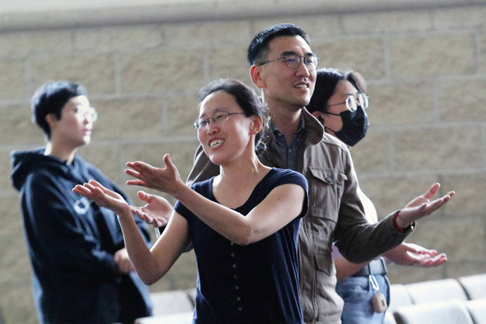 Attendees of the June 13 young adult worship service at First Korean United Methodist Church in Wheeling, Ill., bless each other during a time of praise. Photo by the Rev. Thomas Kim, UM News.