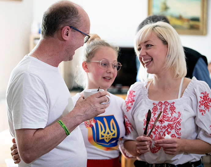 The Rev. Zdeněk Neužil of The United Methodist Church in the Czech Republic visits with Ukrainian refugees Anna and her daughter Polina at the Veselka United Methodist retreat center. Neužil serves as caretaker at the retreat home. Photo by Mike DuBose, UM News.