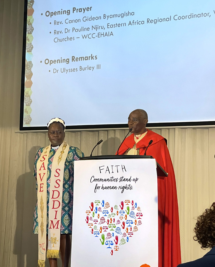 Opening prayers at the 24th International AIDS Conference, July 29-Aug. 2 in Montreal, Canada, are led by the Rev. Canon Gideon (right), of Byamugisha, Kampala, Uganda, and the Rev. Dr. Pauline Njiru, Eastern Africa regional coordinator, World Council of Churches, in Nairobi, Kenya. Photo by Don Messer.