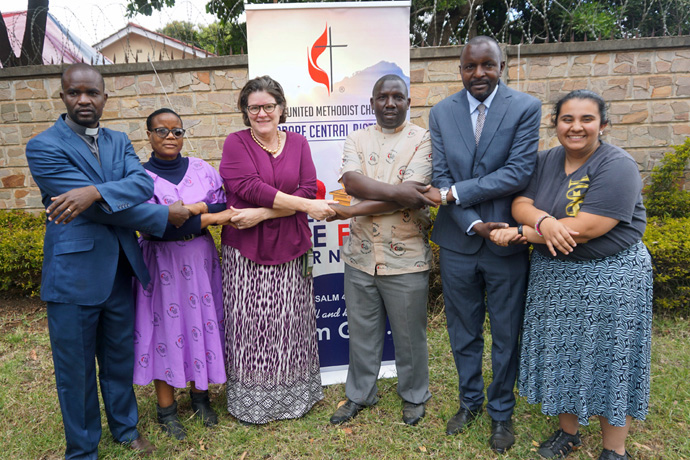 Church leaders and laity from the Northwest District of the Indiana Conference and the Zimbabwe Episcopal Area hold hands during a July 13-Aug.4 mission trip. Pictured are (from left) the Rev. Richmond Mauwa, Harare Central District Connectional Ministries director; Agatha Linzi, Harare Central District lay leader; the Rev. Lore Blinn Gibson, Northwest District superintendent; the Rev. Oswell Kaseke, Harare Central District superintendent; Maxwell Maruta, Harare Central District associate lay leader; and Janée LaFuze, Northwest District lay leader. Photo by Kudzai Chingwe, UM News.