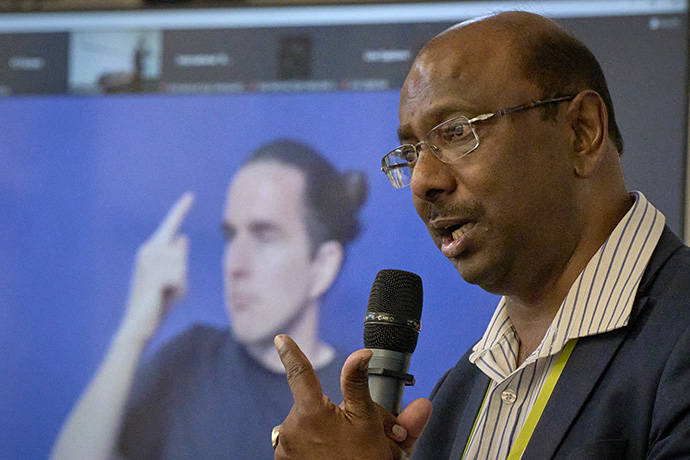 The Rev. Jerry Pillay speaks to the Ecumenical Disability Advocates Network during a gathering on the eve of the assembly. A sign language interpreter can be seen in the background. Pillay was recently elected as the WCC's general secretary. Photo by Paul Jeffrey/WCC.