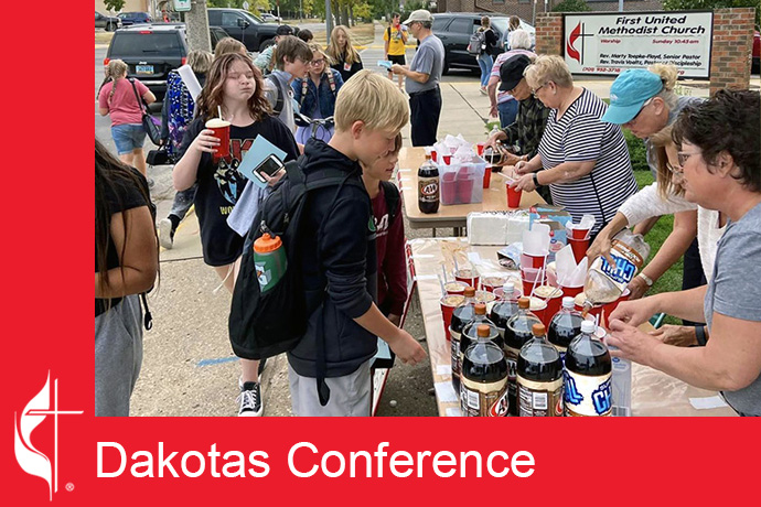 Volunteers from First United Methodist Church in Jamestown, N.D., hand out root beer floats and invitations to their after-school program. Photo from First United Methodist Church's Facebook page, courtesy of the Dakotas Conference.