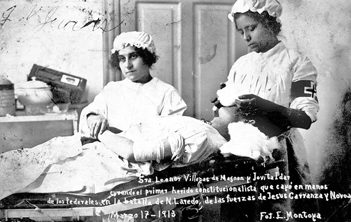 Jovita Idár (right) and Leonor Villegas de Magnon treat a person wounded in the Battle of Nuevo Laredo during the Mexican Revolution in 1913. Photo by E. Montoya, courtesy of the University of Texas at San Antonio Special Collections.