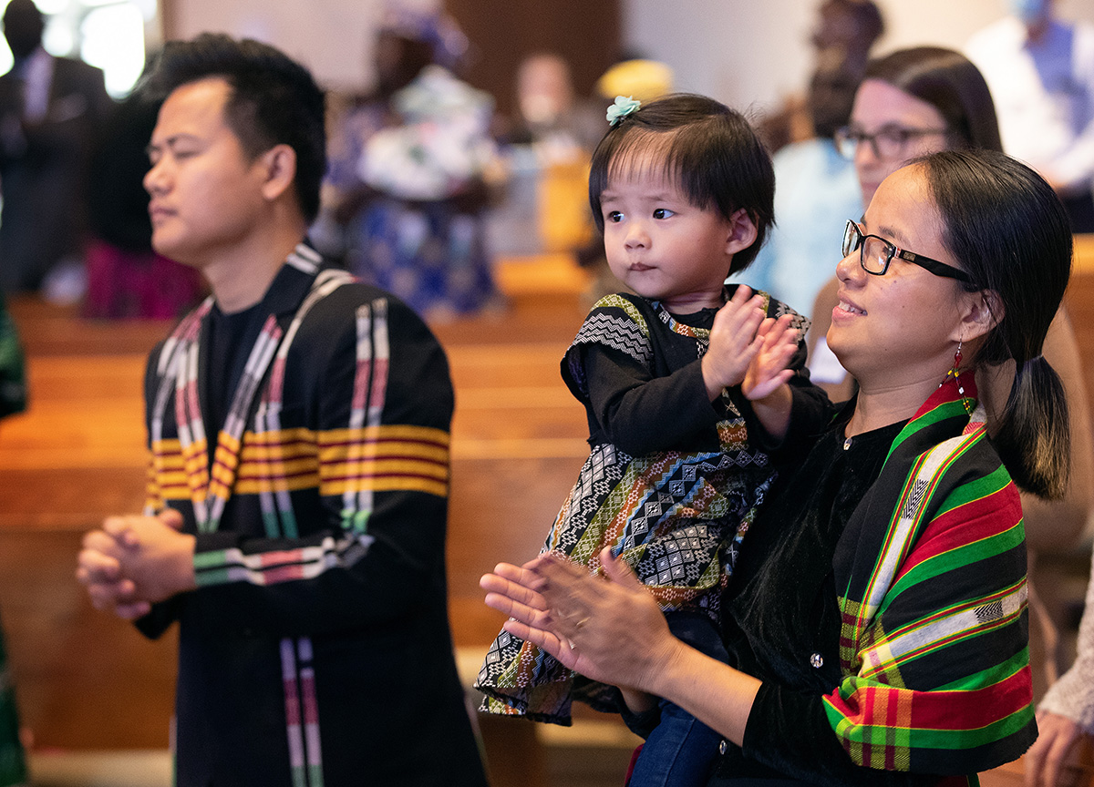 Nadi Nadi (left) and July Ling join in worship with their daughter, Eunice, 2, during a Festival of Nations celebration of World Communion Sunday at Hillcrest United Methodist Church in Nashville, Tenn. The family is part of the El Shaddai congregation that worships in Nepali. Photo by Mike DuBose, UM News.