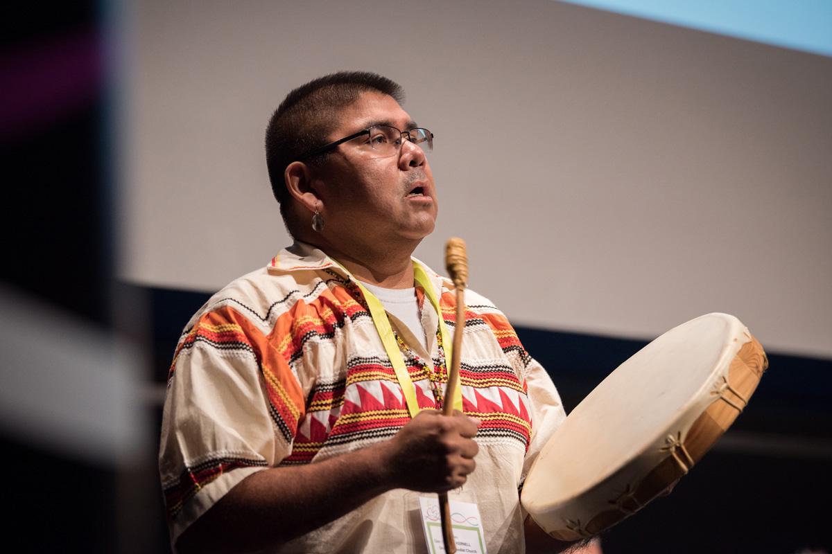 The Rev. Glen “Chebon” Kernell, who is Native American, sings and beats a drum during a joint opening prayer on Aug. 29 during pre-assemblies to the 11th Assembly of the World Council of Churches in Karlsruhe, Germany. Kernell is the executive director of the United Methodist Native American Comprehensive Plan. Photo by Albin Hillert, World Council of Churches.