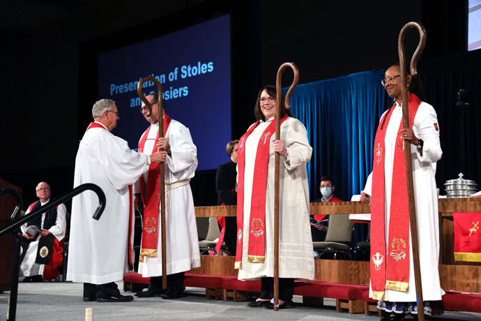 Bishop Bruce Ough (left) presents crosiers to newly elected Bishops Dan Schwerin, Lanette Plambeck (center) and Kennetha Bigham-Tsai during the North Central Jurisdiction’s consecration service on Nov. 5 in Fort Wayne, Ind. Photo courtesy of the North Central Jurisdiction. 