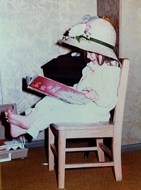 Sheila Carrasco reads a Dr. Seuss book. Carrasco, one of the stars of the CBS show “Ghosts,” began performing as a child, starring in community theater productions of “Annie” and “Oliver!” Photo courtesy of Joyce Carrasco. 