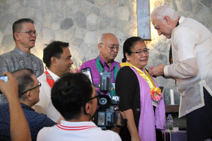 Newly elected Bishop Ruby-Nell Estrella receives her episcopal pin from College of Bishops President Thomas J. Bickerton (right) during the Philippines Central Conference at Wesleyan University-Philippines in Cabanatuan City, Philippines. Estrella is the first woman to be elected a United Methodist bishop in the Philippines. Photo by Gladys P. Mangiduyos, UM News. 