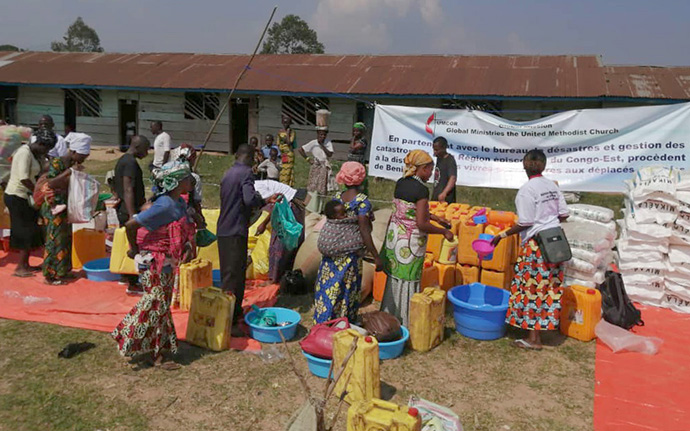 Recipients line up to receive vegetable oil, rice, salt, sugar and other aid distributed by The United Methodist Church in Beni, Congo. Money from the United Methodist Committee on Relief purchased 38 tons of food for displaced families in Beni. Photo by Chadrack Tambwe Londe, UM News.