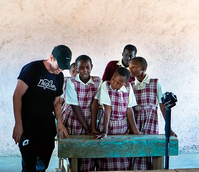 James Barnett (left) works with students from Ndibai Primary School in Kenya to create a video for the ministryâs donors, who helped fund the studentsâ uniforms. Photo courtesy of Kristin Barnett.