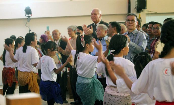 Bishop Ciriaco Q. Francisco (looking at camera) along with (to his right) Bishop Rodolfo A. Juan, former Philippines Supreme Court Chief Justice Reynato S. Puno, Council of Bishops President Thomas Bickerton, Bishop Pedro M. Torio Jr. and retired Bishop Leo A. Soriano clap along during the Revive 3 worship service at Wesleyan University-Philippines Chapel in Cabanatuan City, Philippines. Photo by Gladys P. Mangiduyos, UM News. 