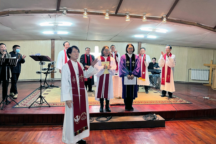 Bishop Jeremiah Park (in front) introduces the Revs. Urjinkhand (purple robe) and Munkhnaran (white robe), the first local elders of the United Methodist Mongolian Mission Initiative, after he ordained them during the mission’s annual meeting at Gerelt United Methodist Church in Ulaanbaatar, Mongolia, on Oct. 3. Photo courtesy of the Asia Regional Office, United Methodist Board of Global Ministries.
