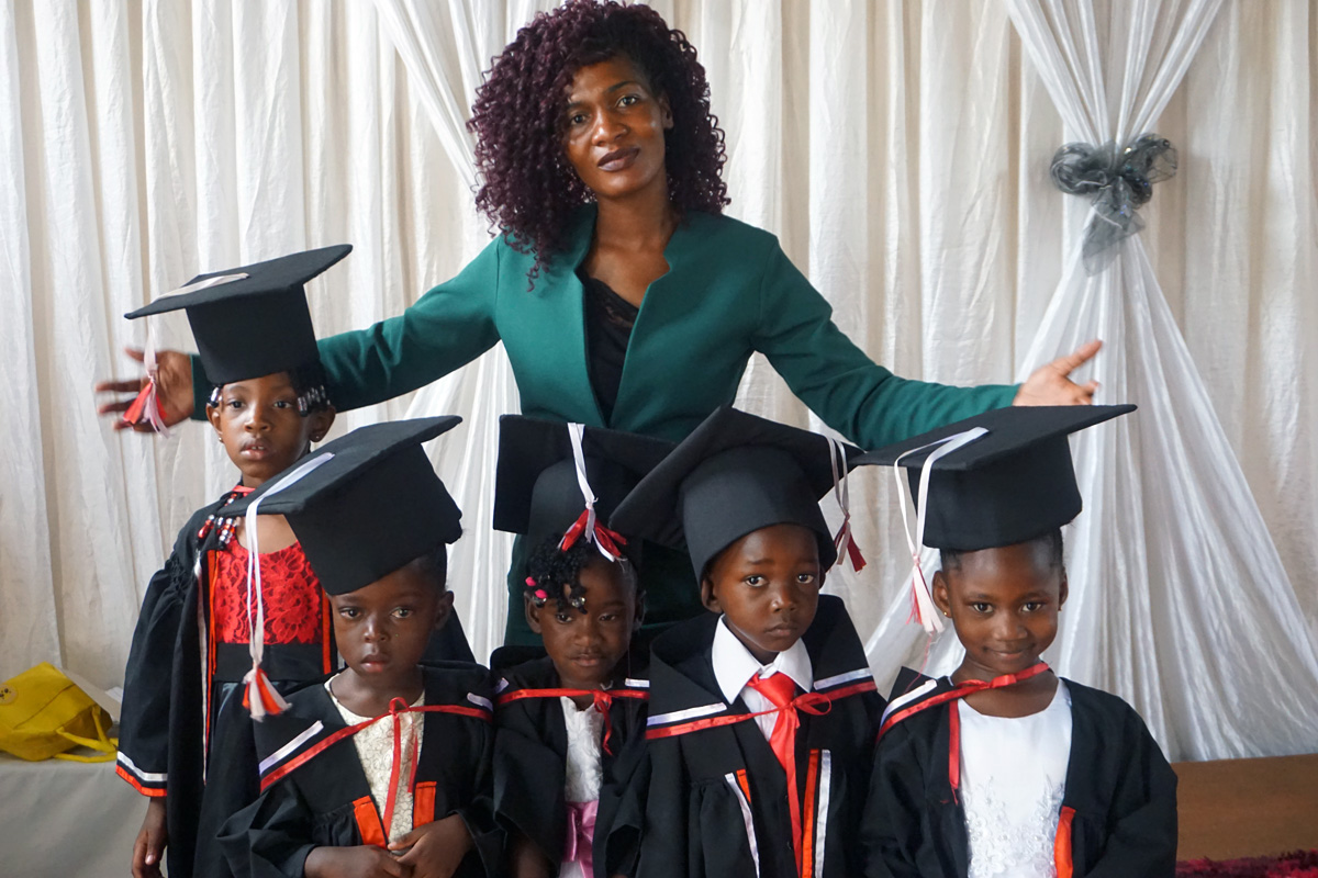 Pauline Violet Mushati poses with graduates of the United Methodist Church’s Barrington Christian School in Harare, Zimbabwe. Mushati is a teacher at the school, which opened in 2021. It is one of two state-of-the-art private schools in Harare founded by The United Methodist Church in Zimbabwe. Photo by Kudzai Chingwe, UM News.