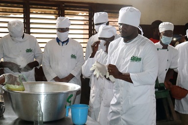 Participants of a training program at the Songhai Center in Porto-Novo, Benin, learn how to bottle pineapple juice once the processing is complete. The training, part of The United Methodist Church’s Yambasu Agriculture Initiative, gives farmers first-hand experience in sustainable agriculture. Photo by Phileas Jusu, UM News.