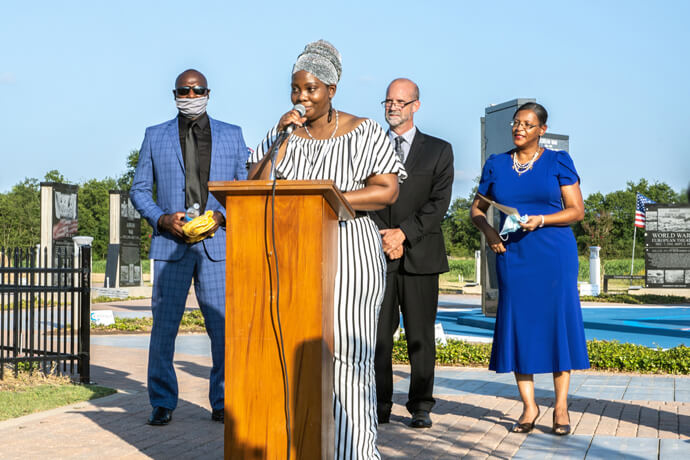 Janese Walton Arthur, a descendant of 1920 lynching victim Herman Arthur, speaks at a July 5, 2020, ceremony of acknowledgement, lament and reconciliation in Paris, Texas. She’s joined by (from left) the Rev. Gary Savage, the Rev. Rob Spencer and the Rev. Shay Easter-Bills. The role of Spencer, a United Methodist, in encouraging Paris to confront its history of lynching is highlighted in the new book “When the Church Woke.” Photo by Libby Slaughter. 