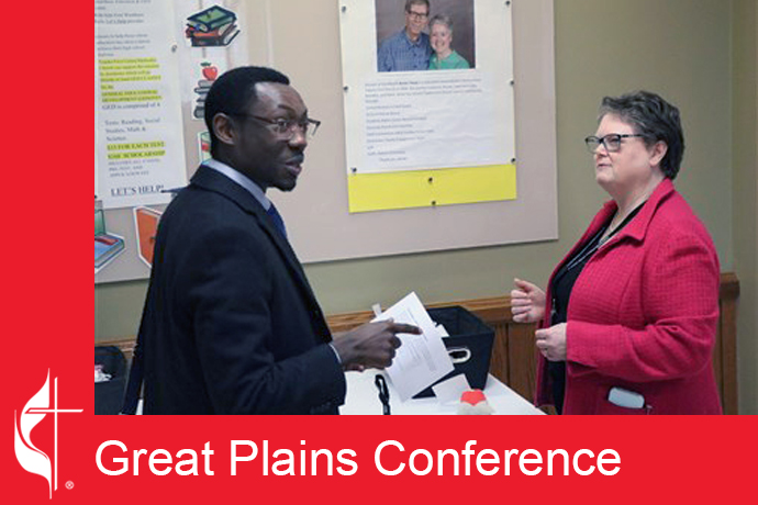 The Rev. Karen Jeffcoat gives instructions to Yves Kinangwa, pastor at Coffeyville-Edna, before lunch break during the Great Plains Conference Board of Ordained Ministry credentialing process. Photo courtesy of the Great Plains Conference.