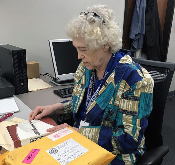 Frances Long, the archivist for First United Methodist Church in Richardson, Texas, and historian for the South Central Jurisdiction, examines a conference manual. Photo courtesy of the North Texas Conference