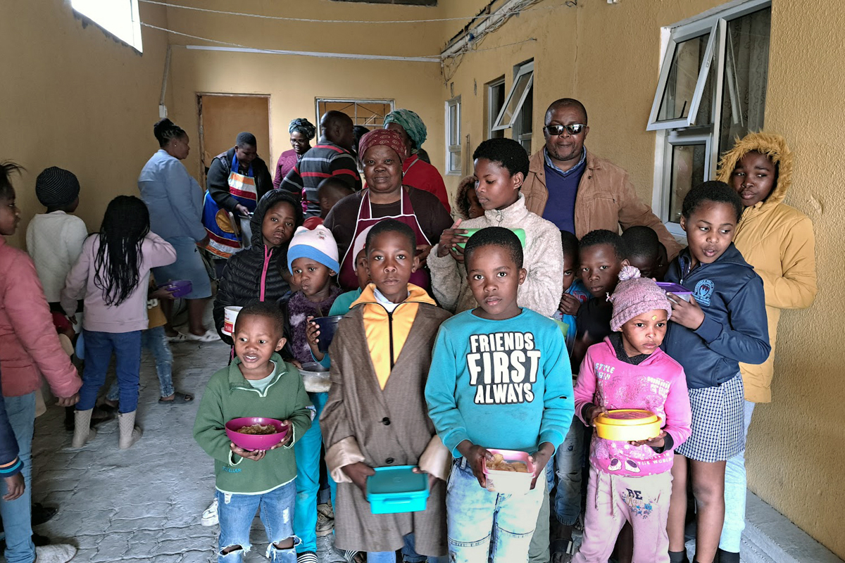 Children from the Philippi neighborhood in Cape Town, South Africa, pose for pictures after receiving meals at Masakhane Soup Kitchen. Many families in the community were hard hit by the COVID-19 pandemic. The food kitchen currently operates twice a week and serves about 200 kids and some parents. Photo by Alvin Makunike, UM News.
